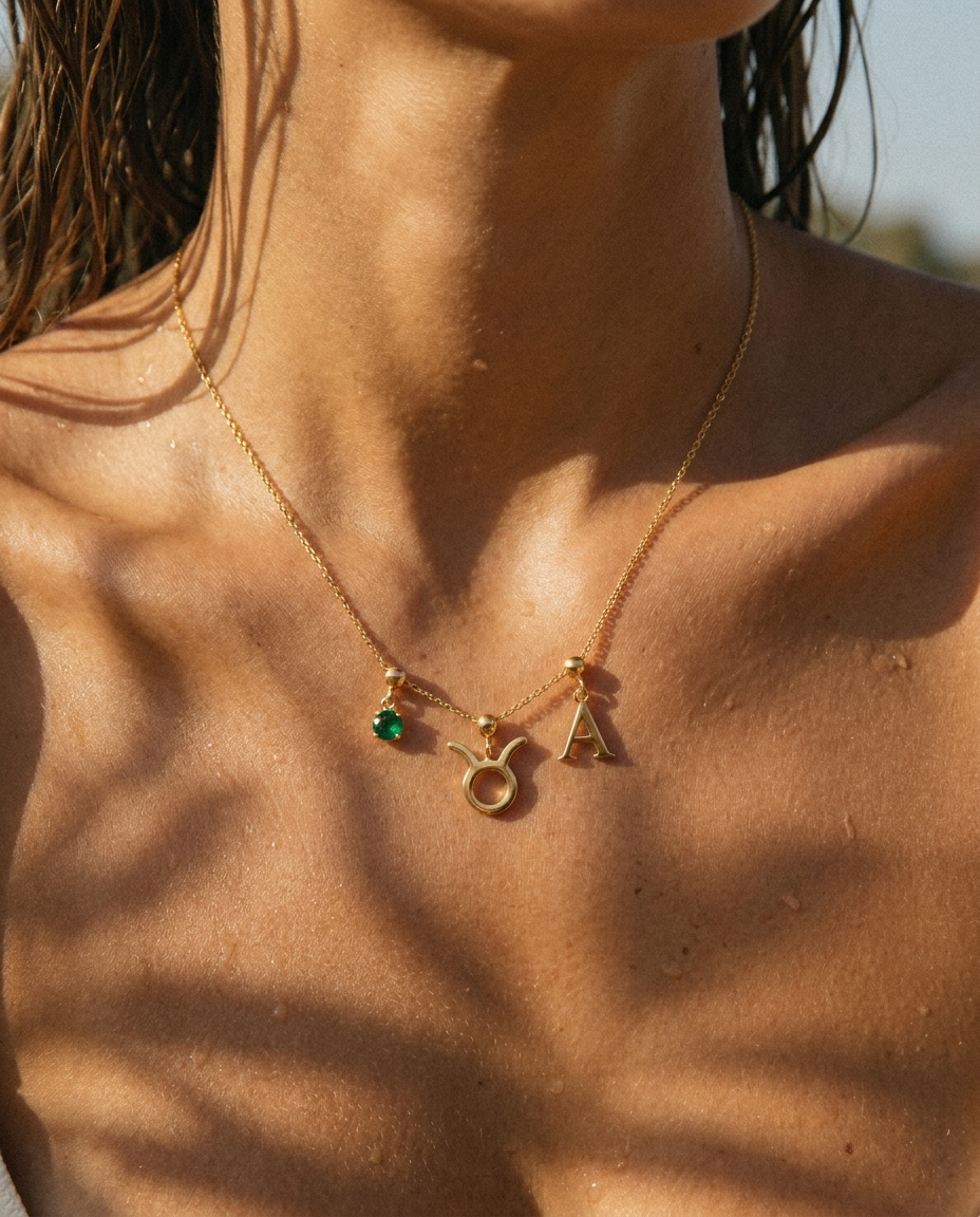 Taurus charm necklace worn, styled with birthstone and initial