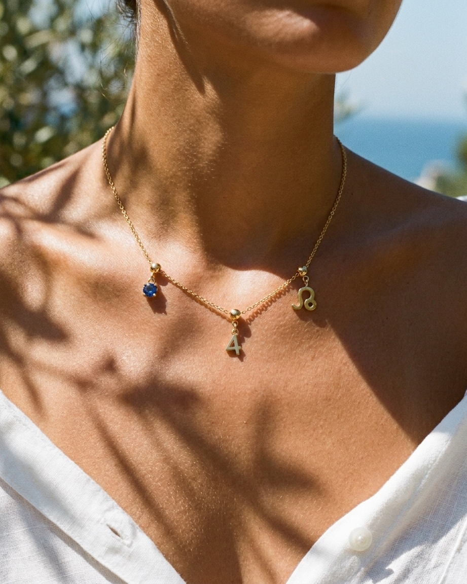 Gold number 4 charm station necklace on model with Leo zodiac and sapphire