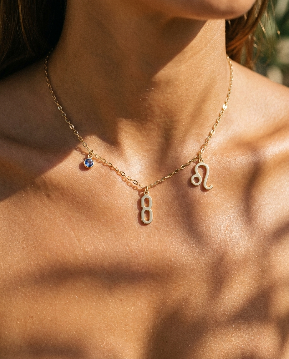 Gold number 8 charm station necklace on model with Leo zodiac and sapphire