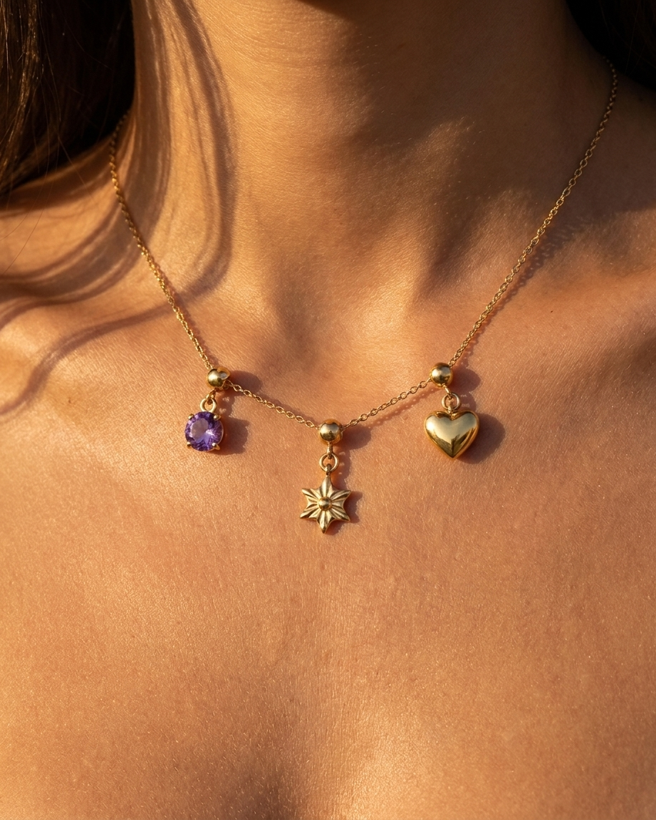 Sunburst star charm styled with February amethyst and heart on chain