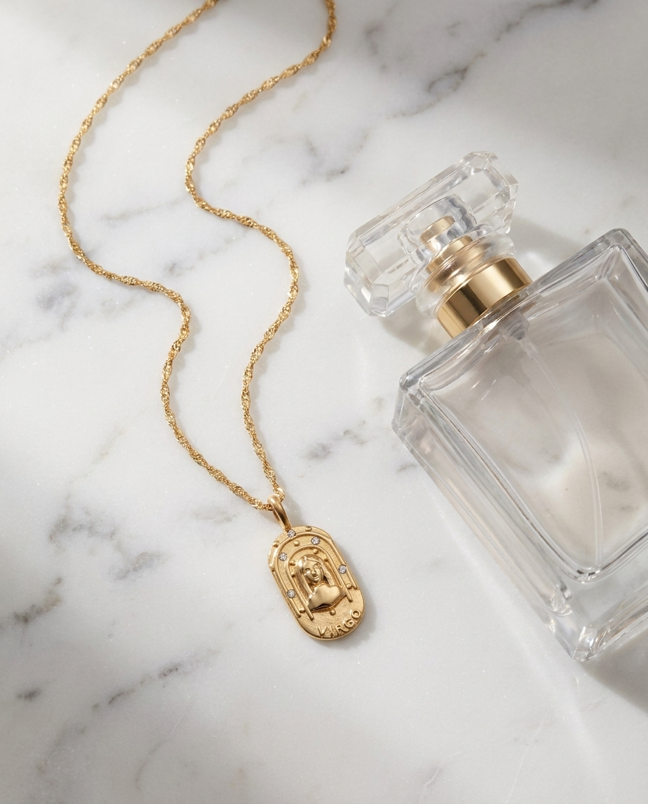 Gold zodiac Virgo pendant necklace flatlay, marble