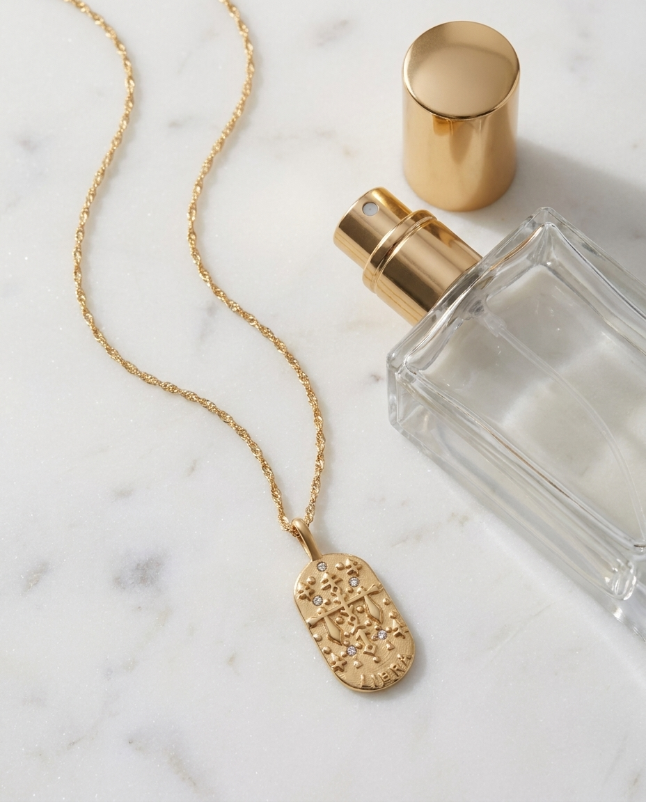 Gold zodiac Libra pendant necklace flatlay, marble