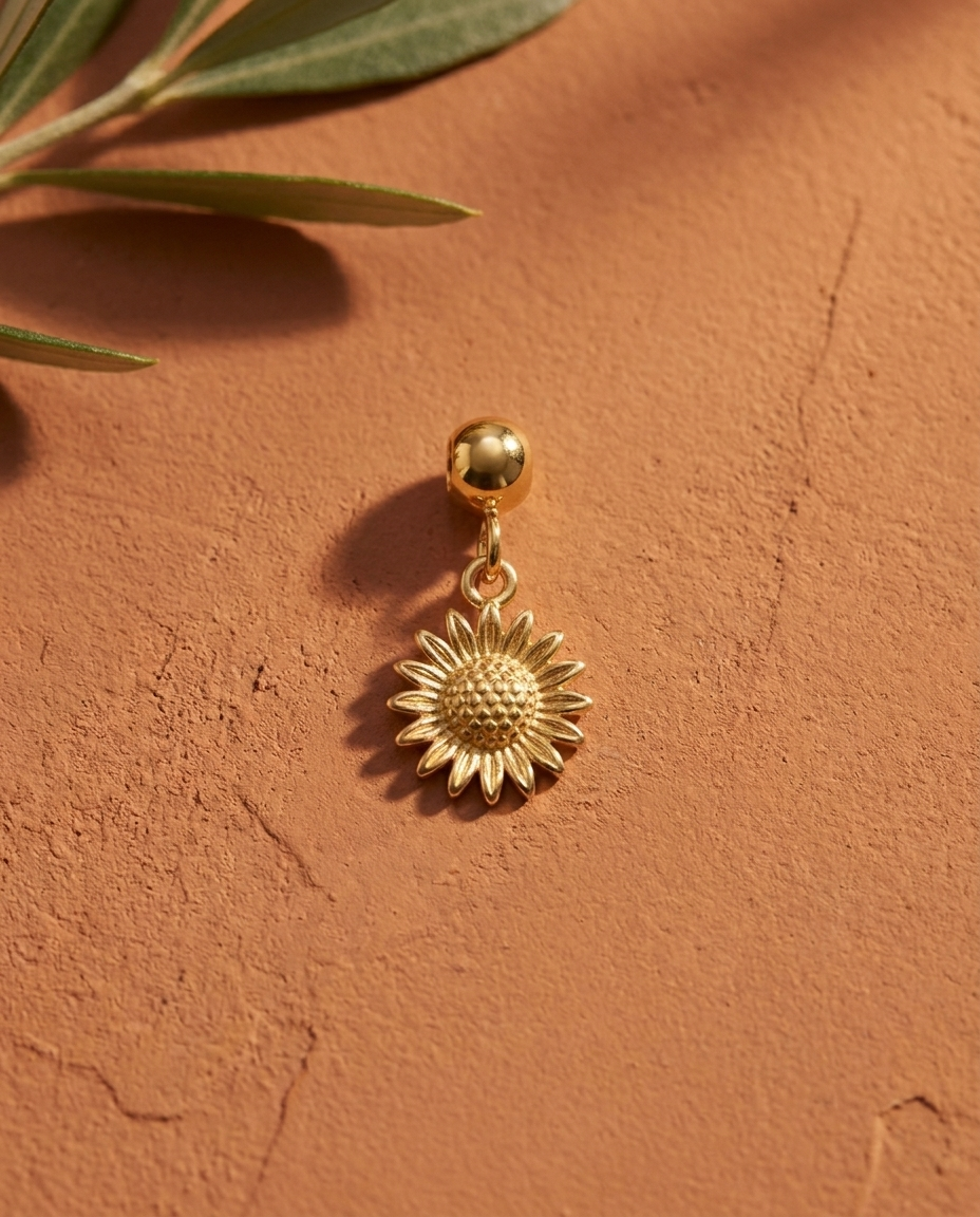 Gold sunflower charm flatlay, terracotta