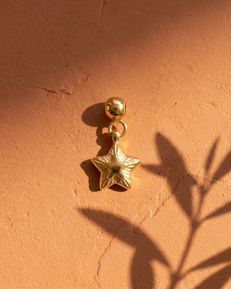 Gold layered star charm flatlay, terracotta