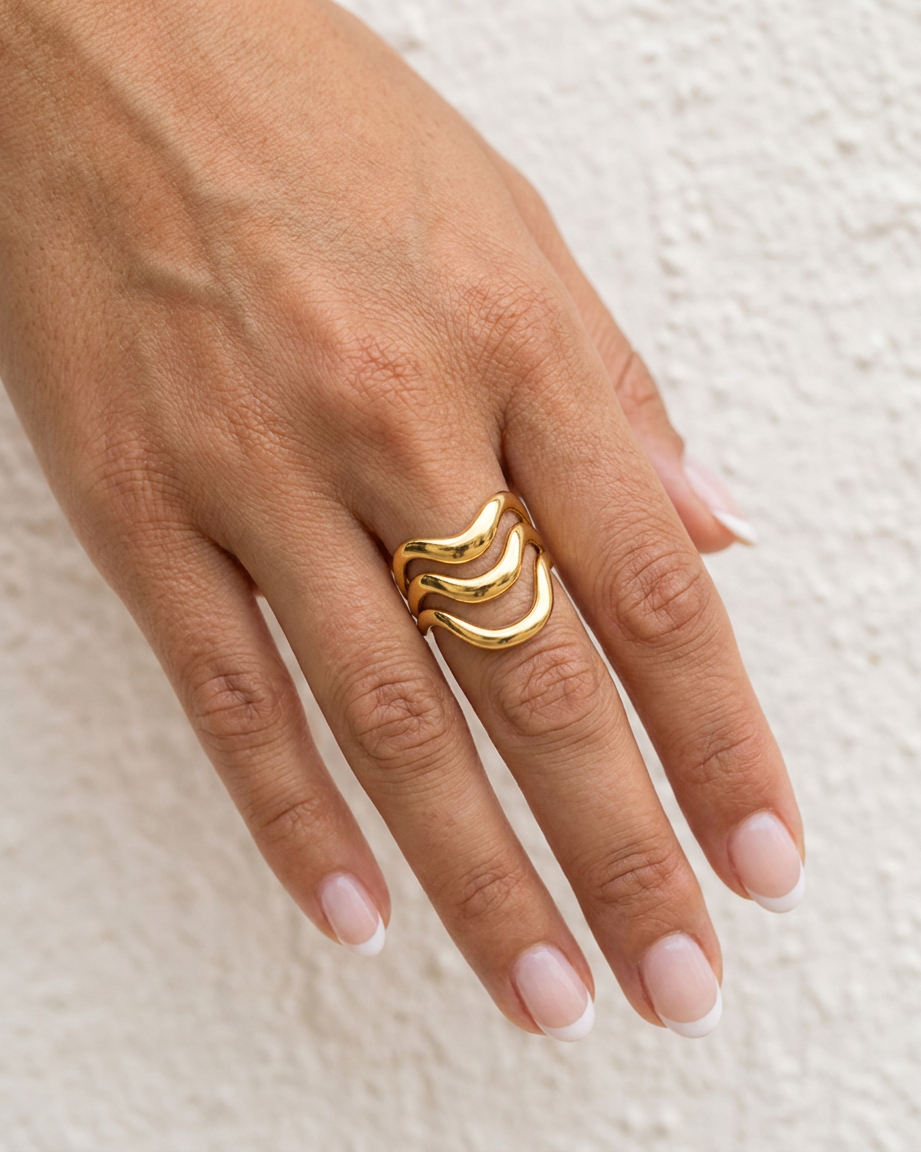 Gold Wave Statement Ring cream wall hand