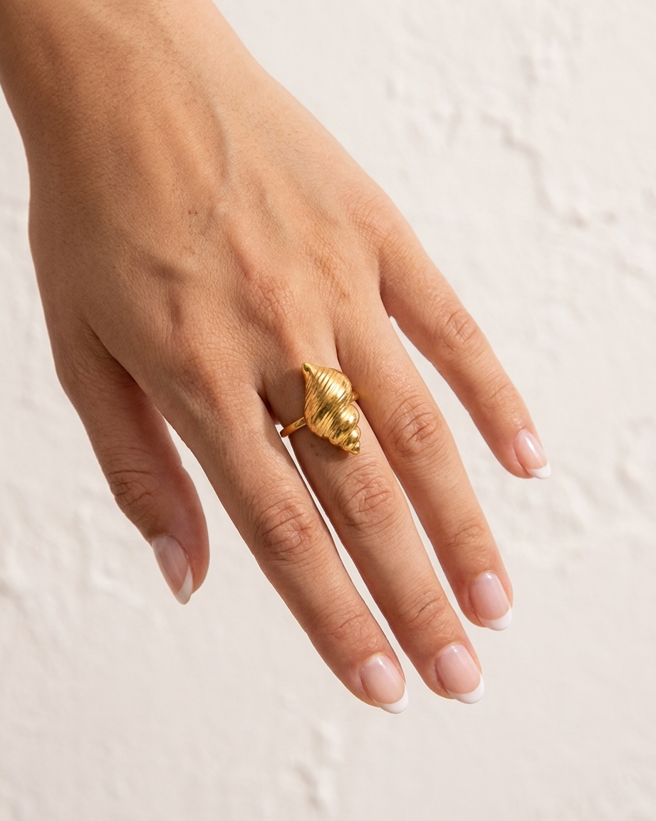 Marisol Golden Seashell Ring cream wall hand