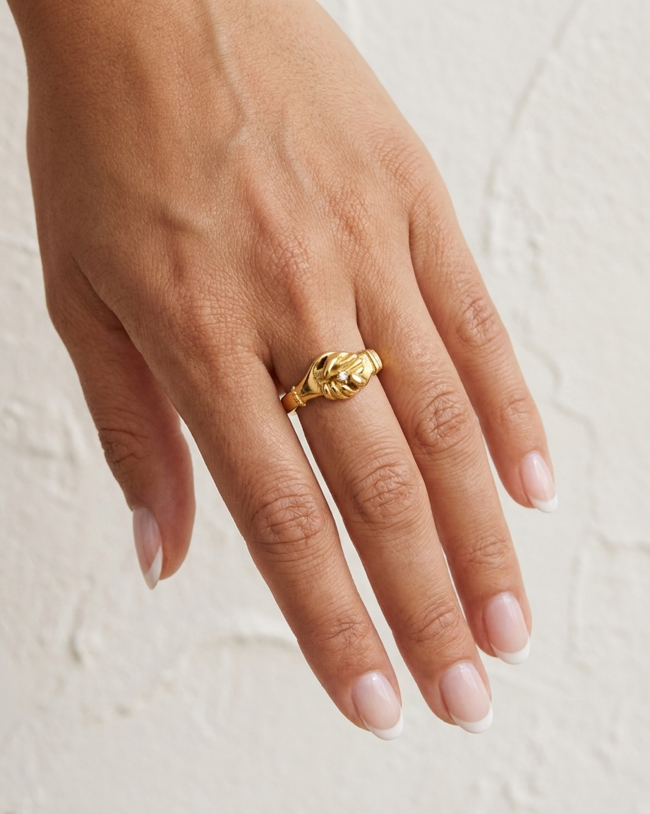 Gold Handshake Ring cream wall hand