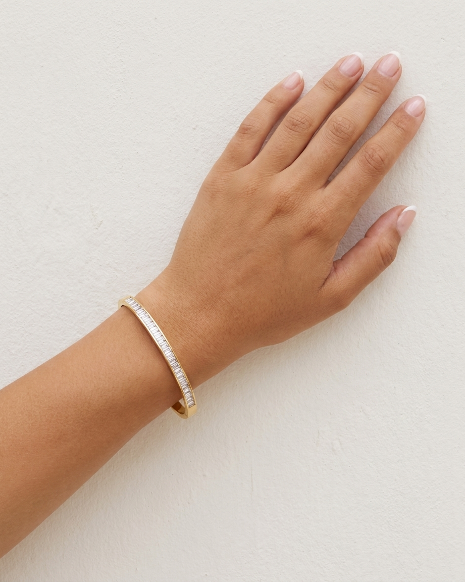 Celine Baguette Bangle on wrist plaster wall