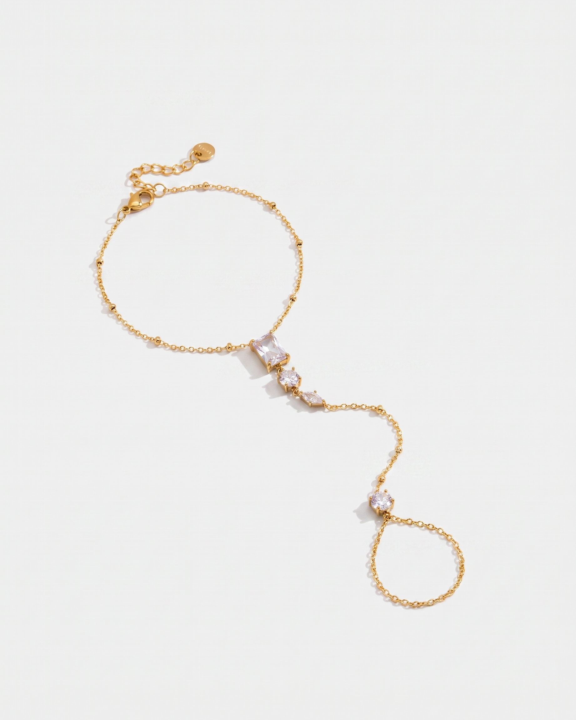 Nadia Hand Chain gold hand chain on light grey background