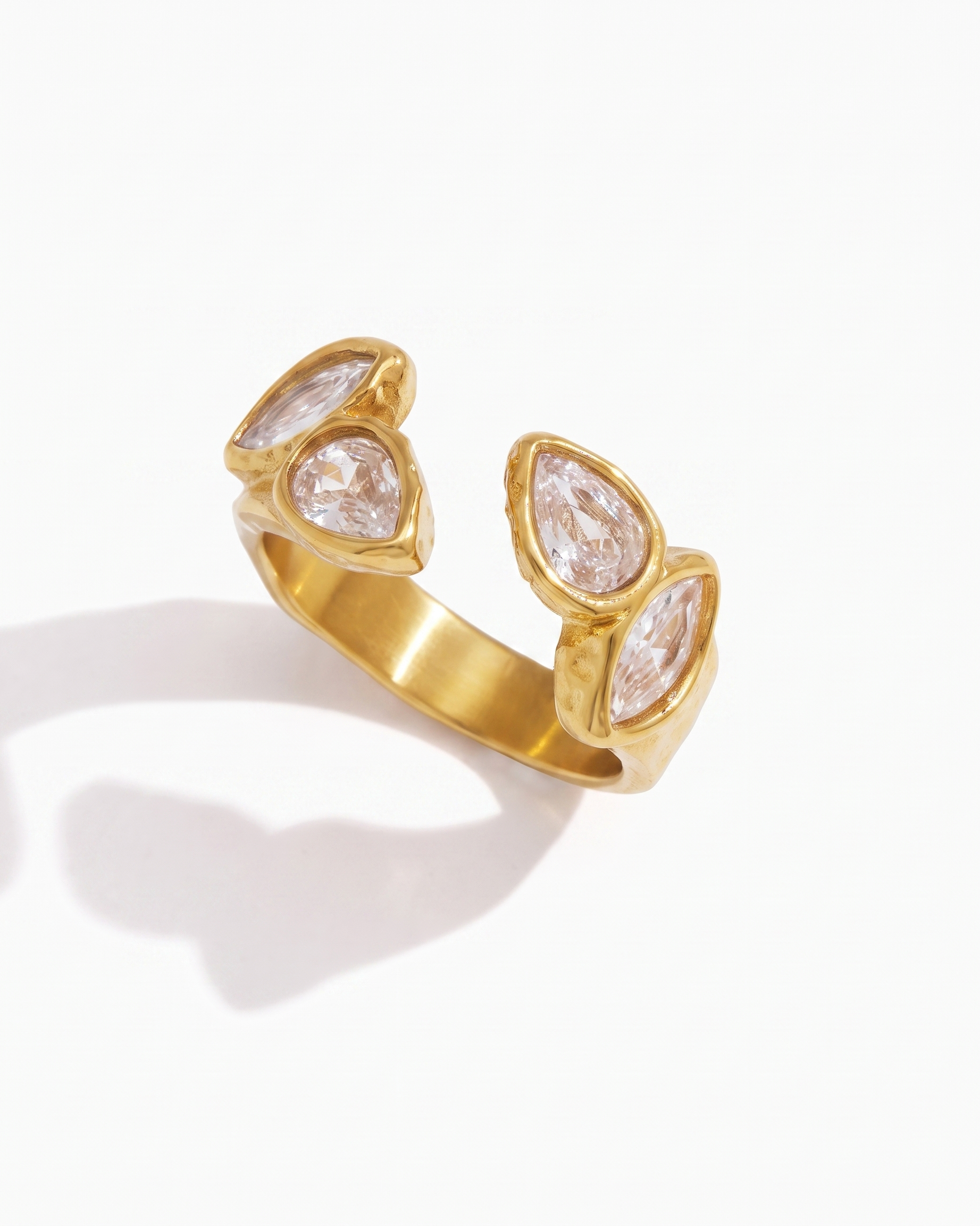 Agathe open zircon ring in 18k gold on off white background