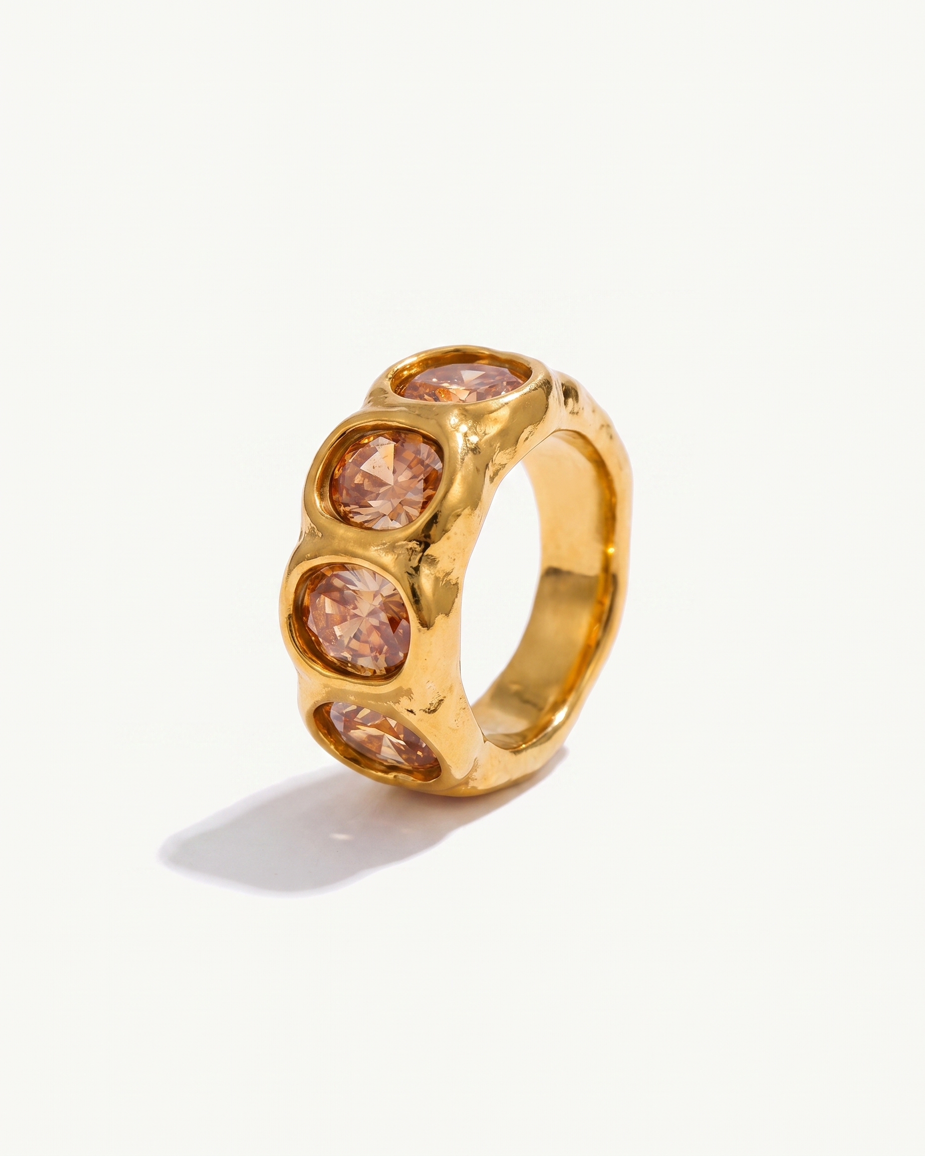 Clemence champagne zircon band ring in 18k gold on off white background