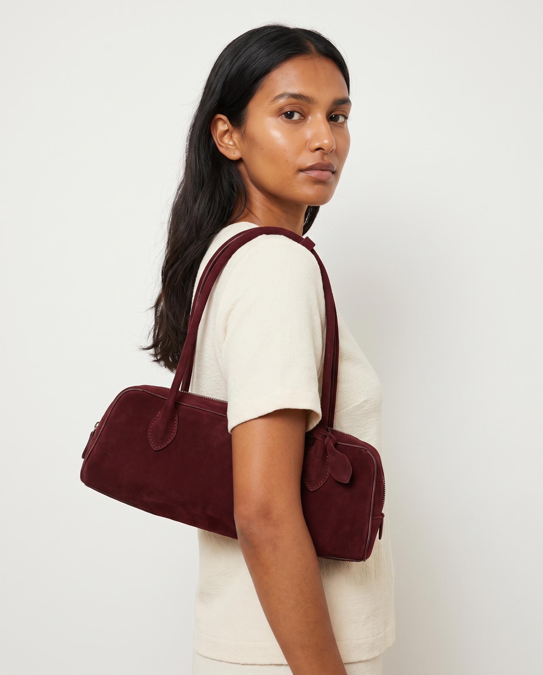 Salome burgundy suede baguette bag worn under the arm