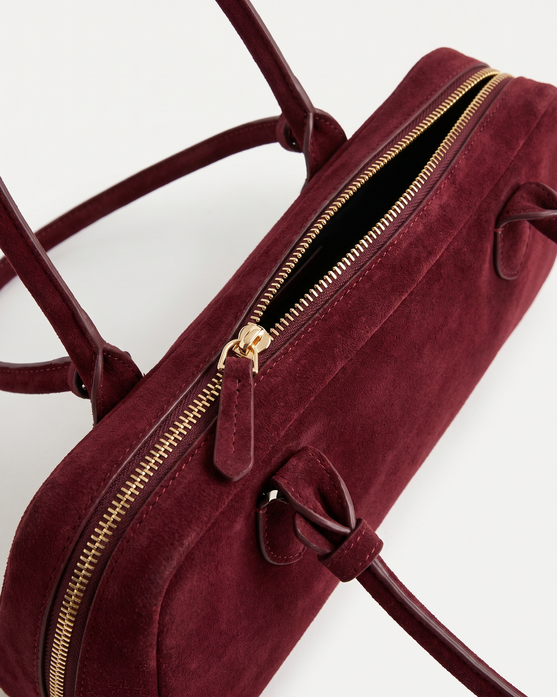 Salome burgundy suede baguette bag zip and tab detail