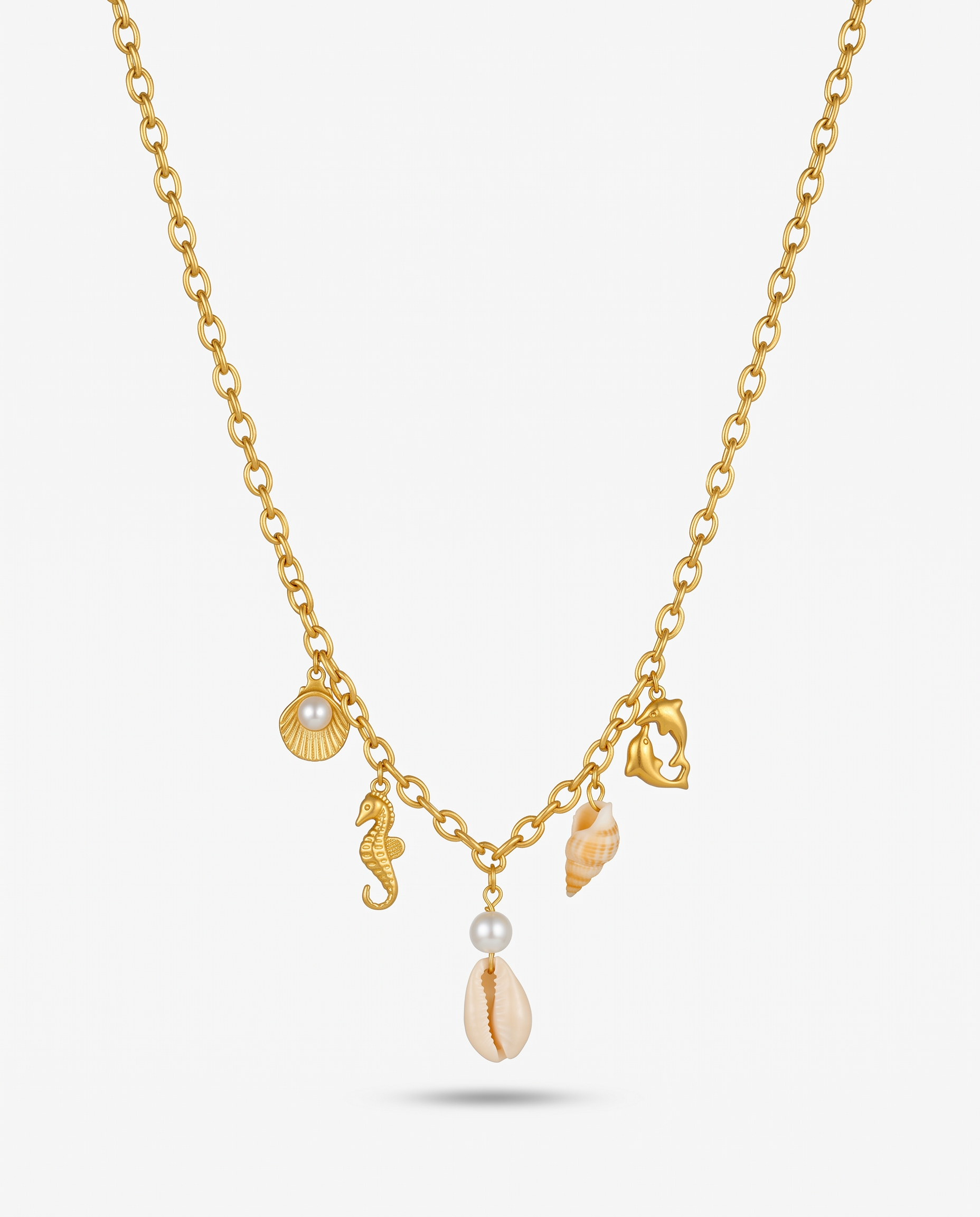 The Shore gold sea charm necklace V-hang on off white background