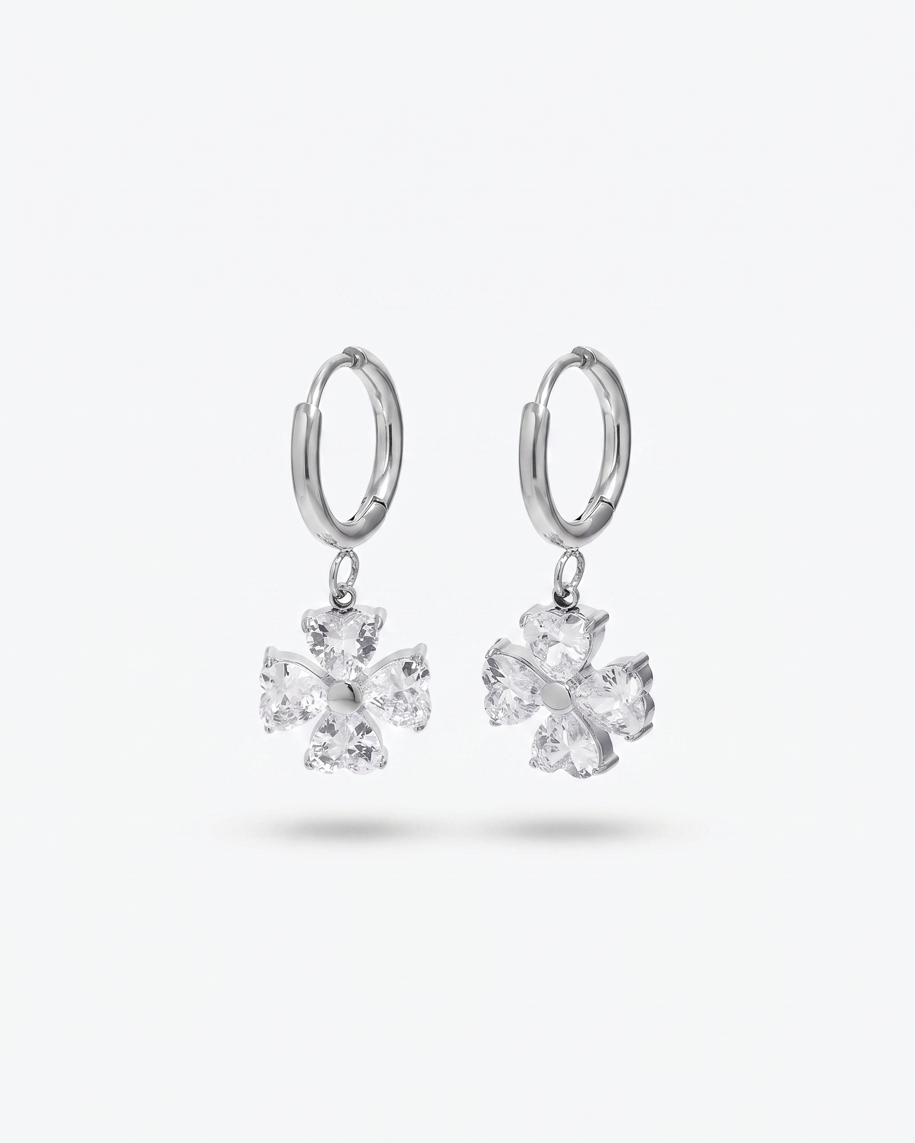 Trefle four leaf clover heart zircon silver hoop earrings pair on off white background