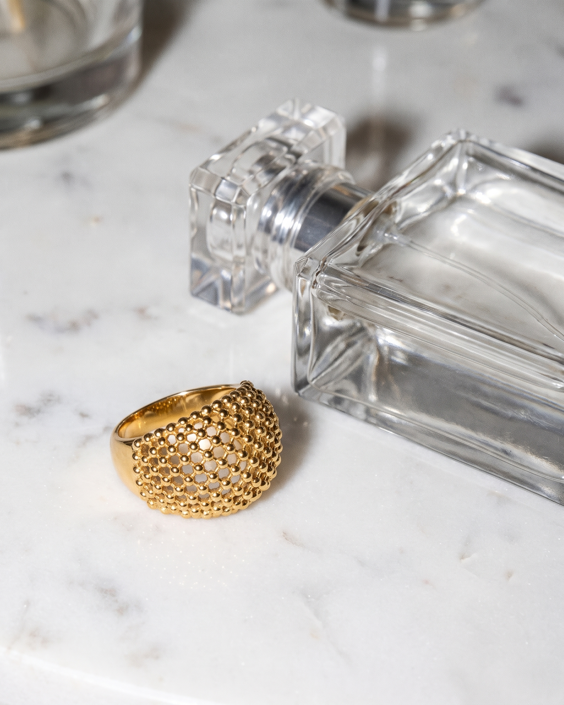 Maille gold dome ring flatlay on marble