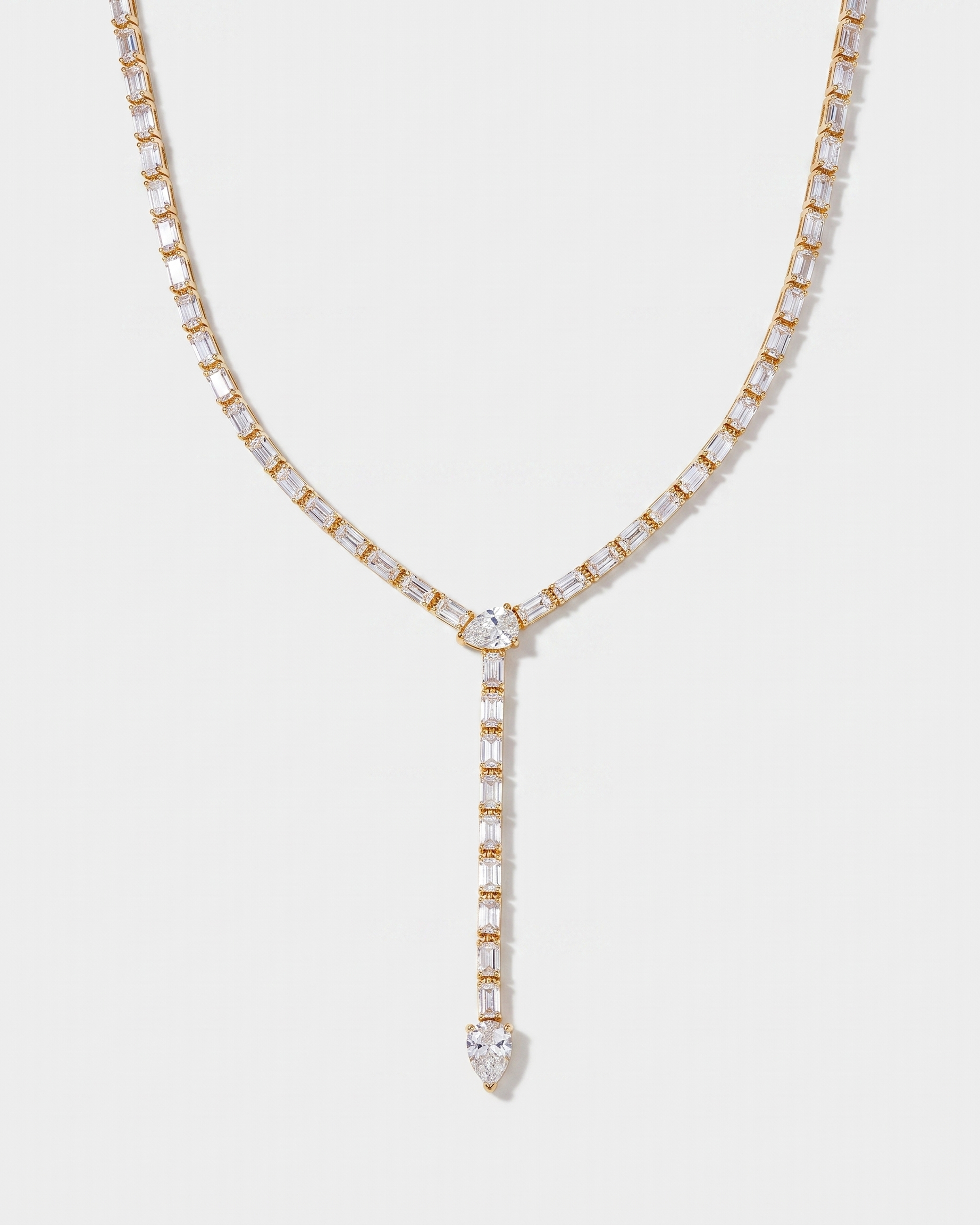 Celeste Y-shaped lariat zircon tennis necklace in gold on off white background