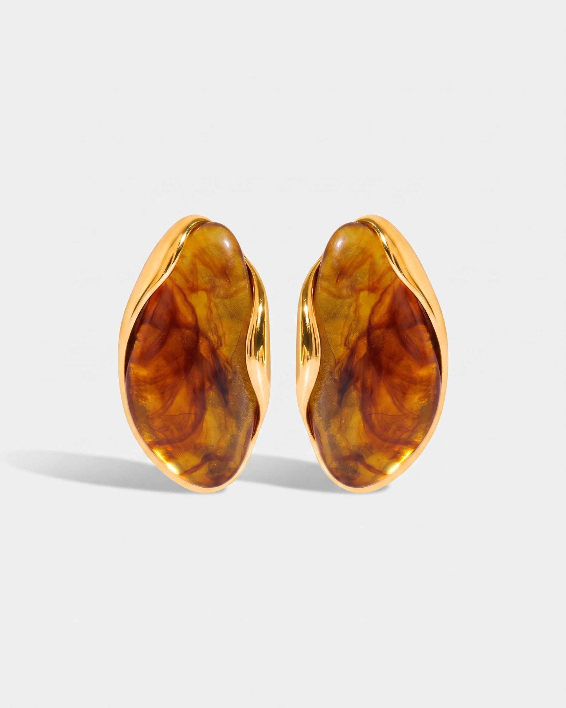 Galet amber pebble studs pair on off white background