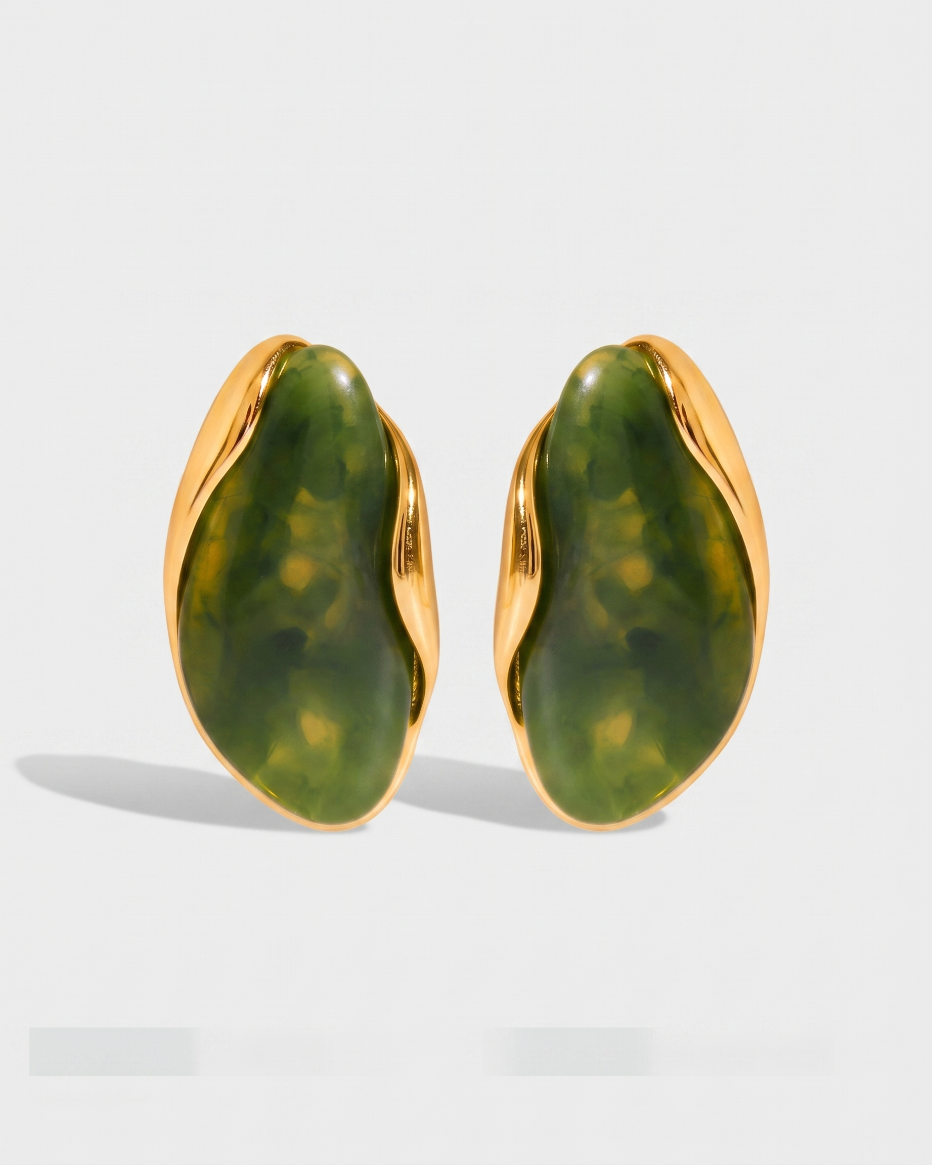 Galet jade pebble studs pair on off white background
