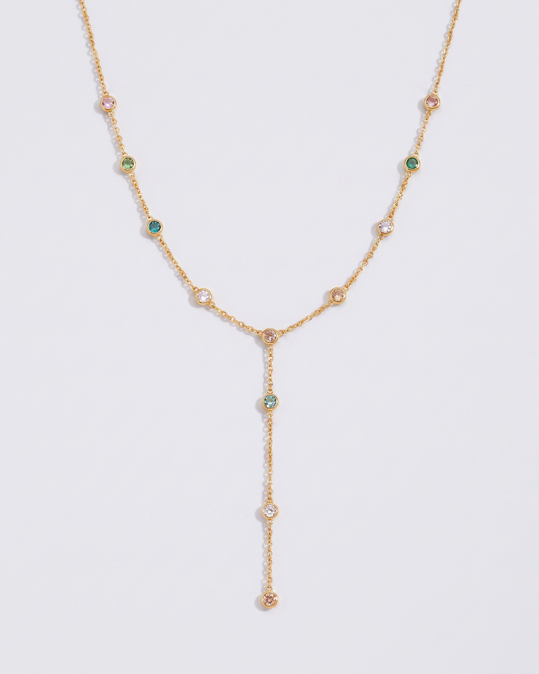 Prisme multicoloured zircon Y-lariat gold necklace on off white background
