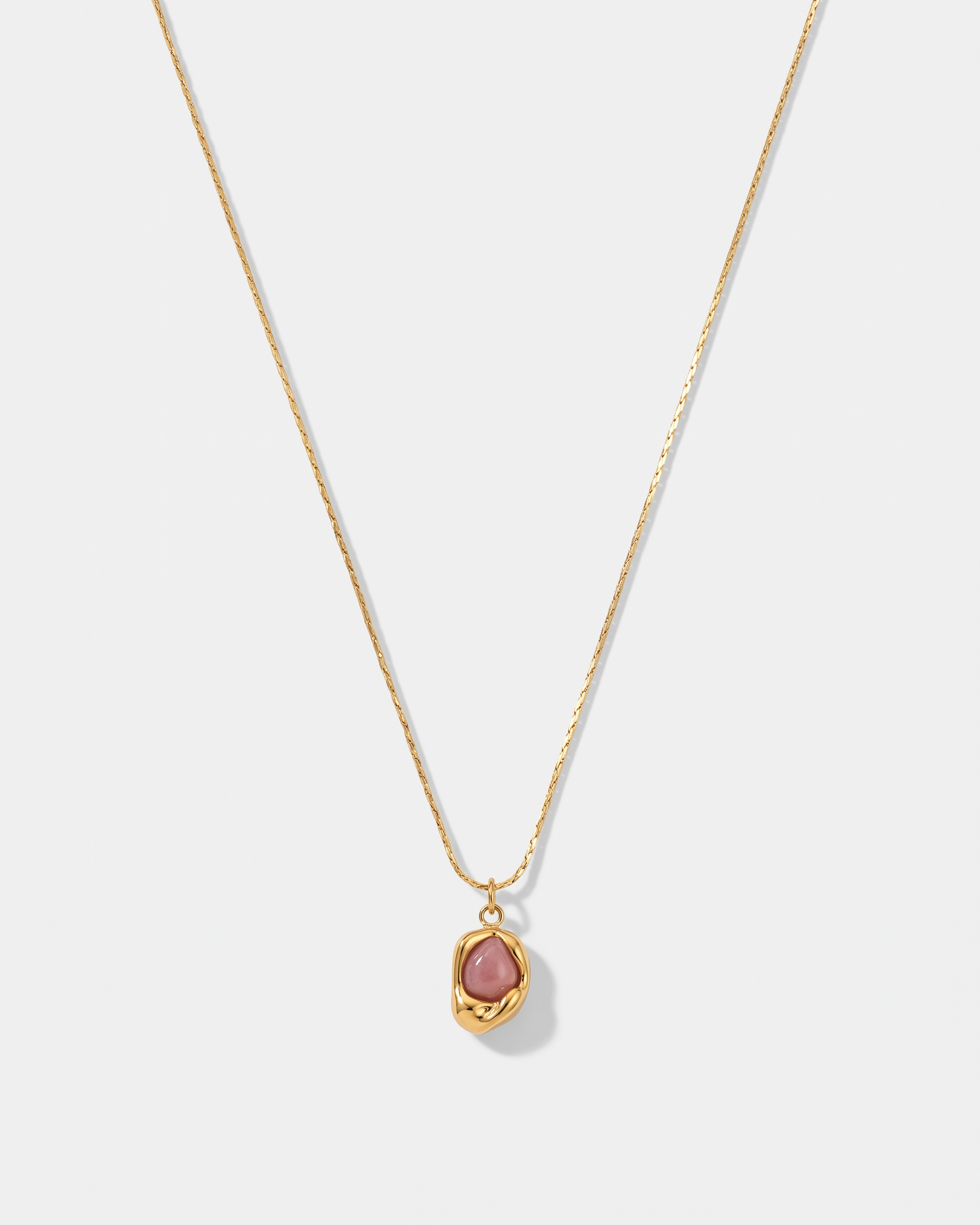 Caillou rose natural stone pendant gold necklace on off white background
