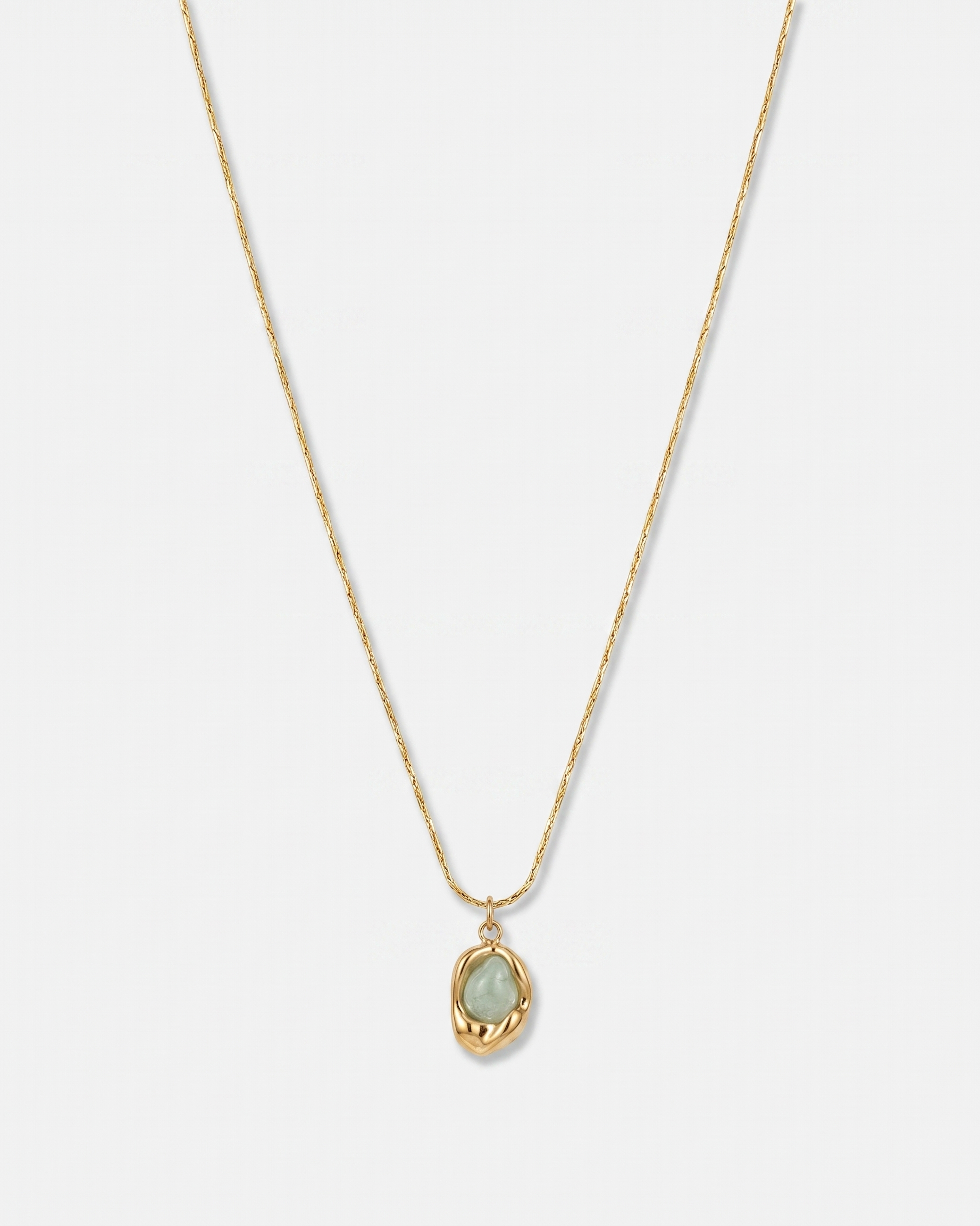 Caillou green natural stone pendant gold necklace on off white background
