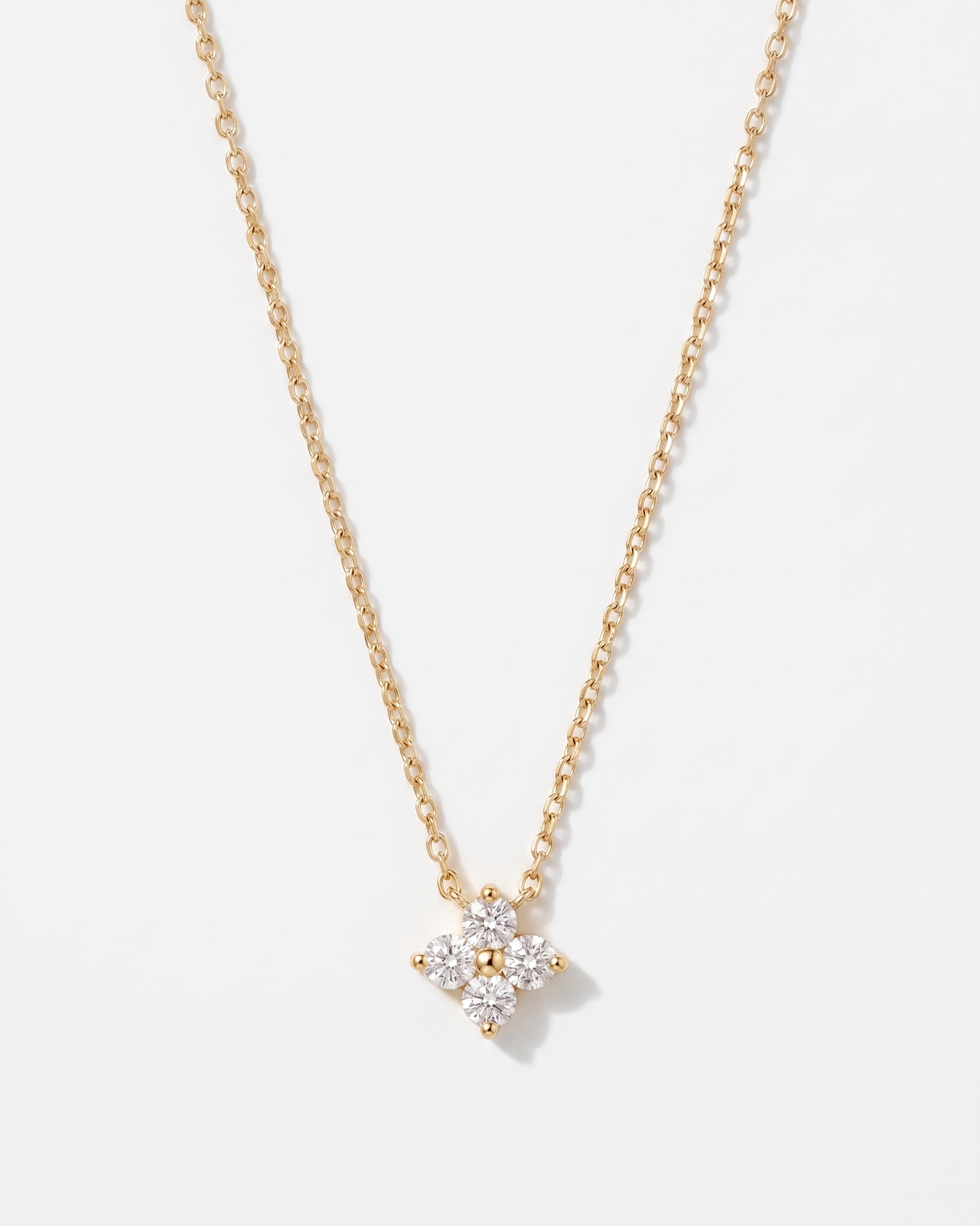Fleur four-leaf flower zircon gold pendant necklace on soft studio background