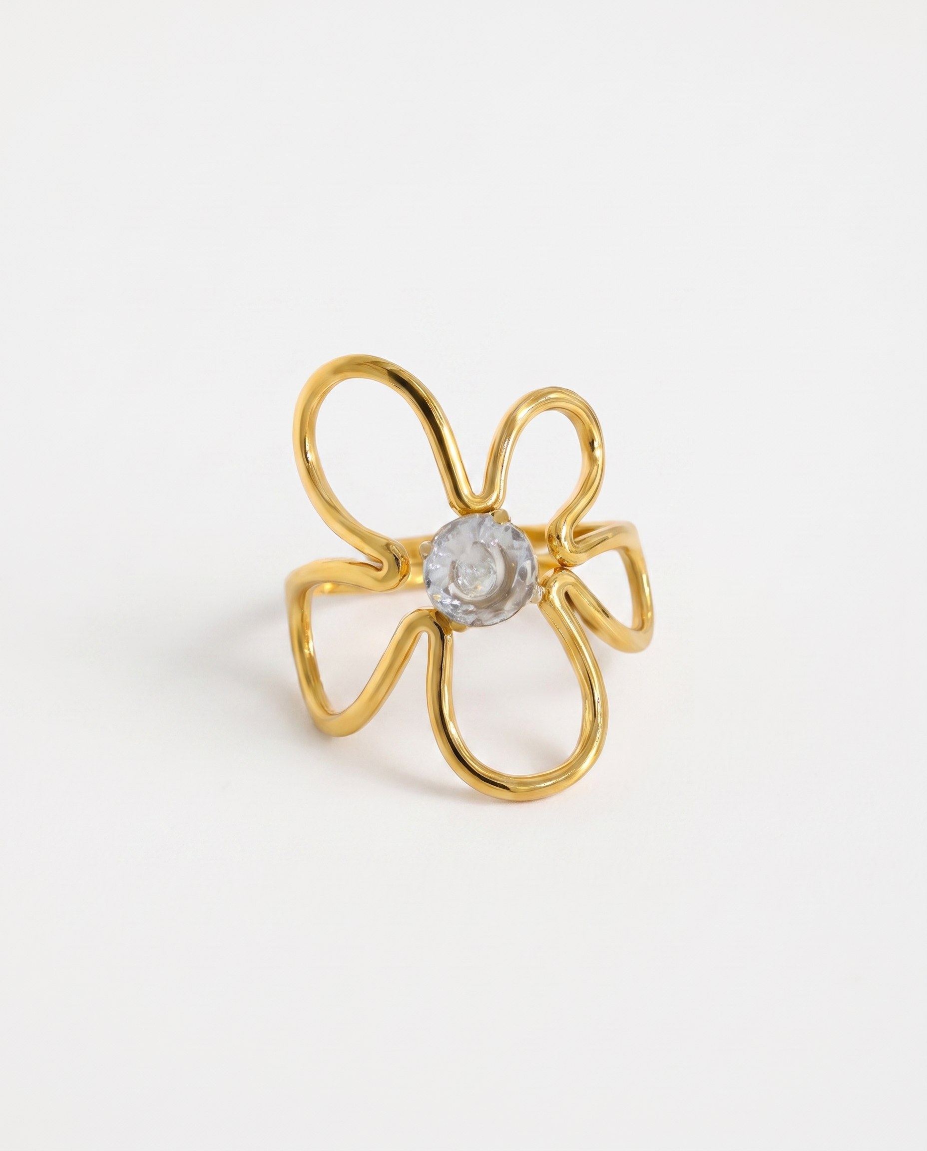 Lou white crystal irregular gold ring on soft studio background