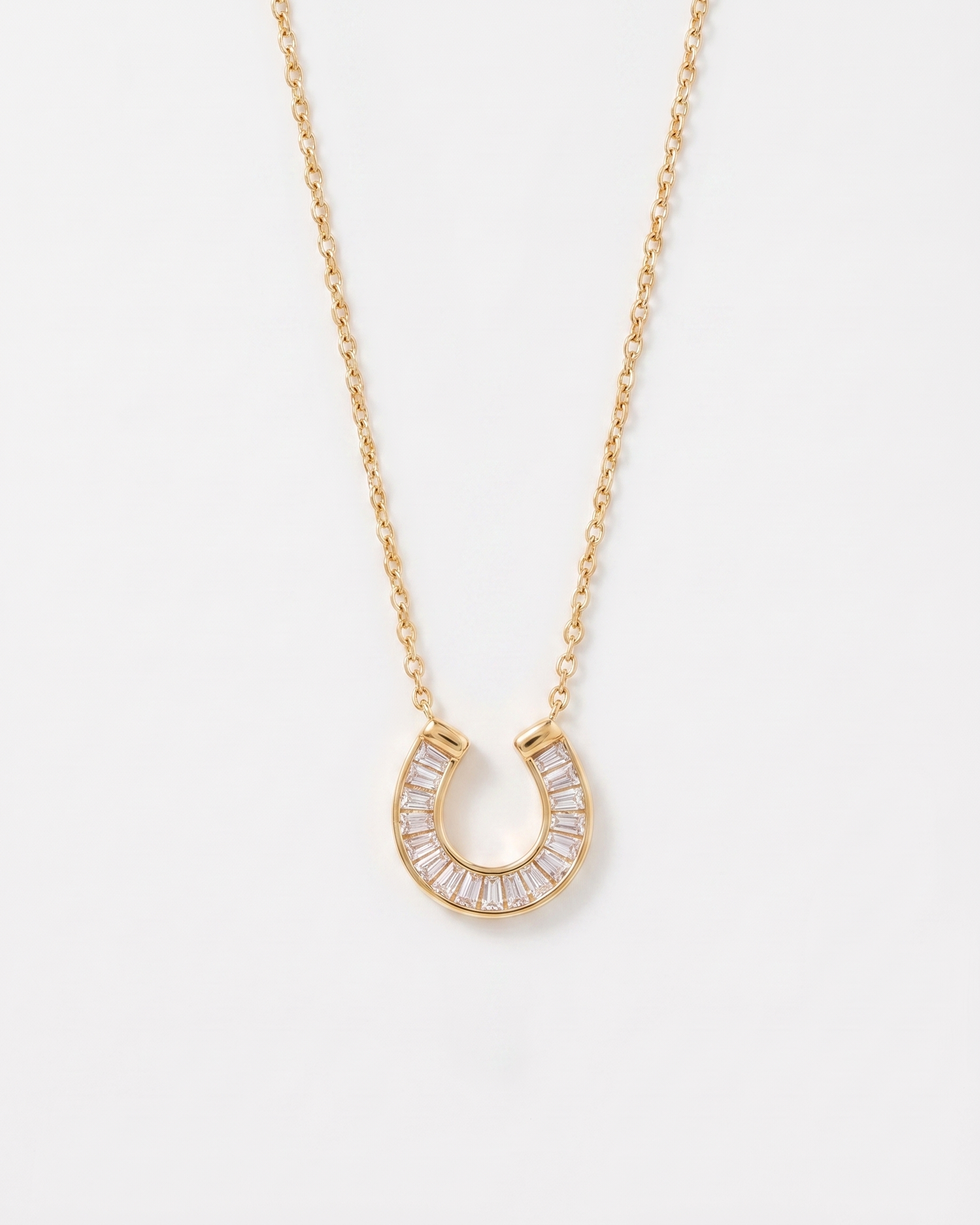 Lucky horseshoe cubic zirconia gold necklace on soft studio background