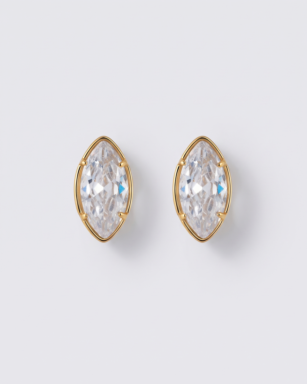 Margaux heart zircon gold stud earrings on off white background