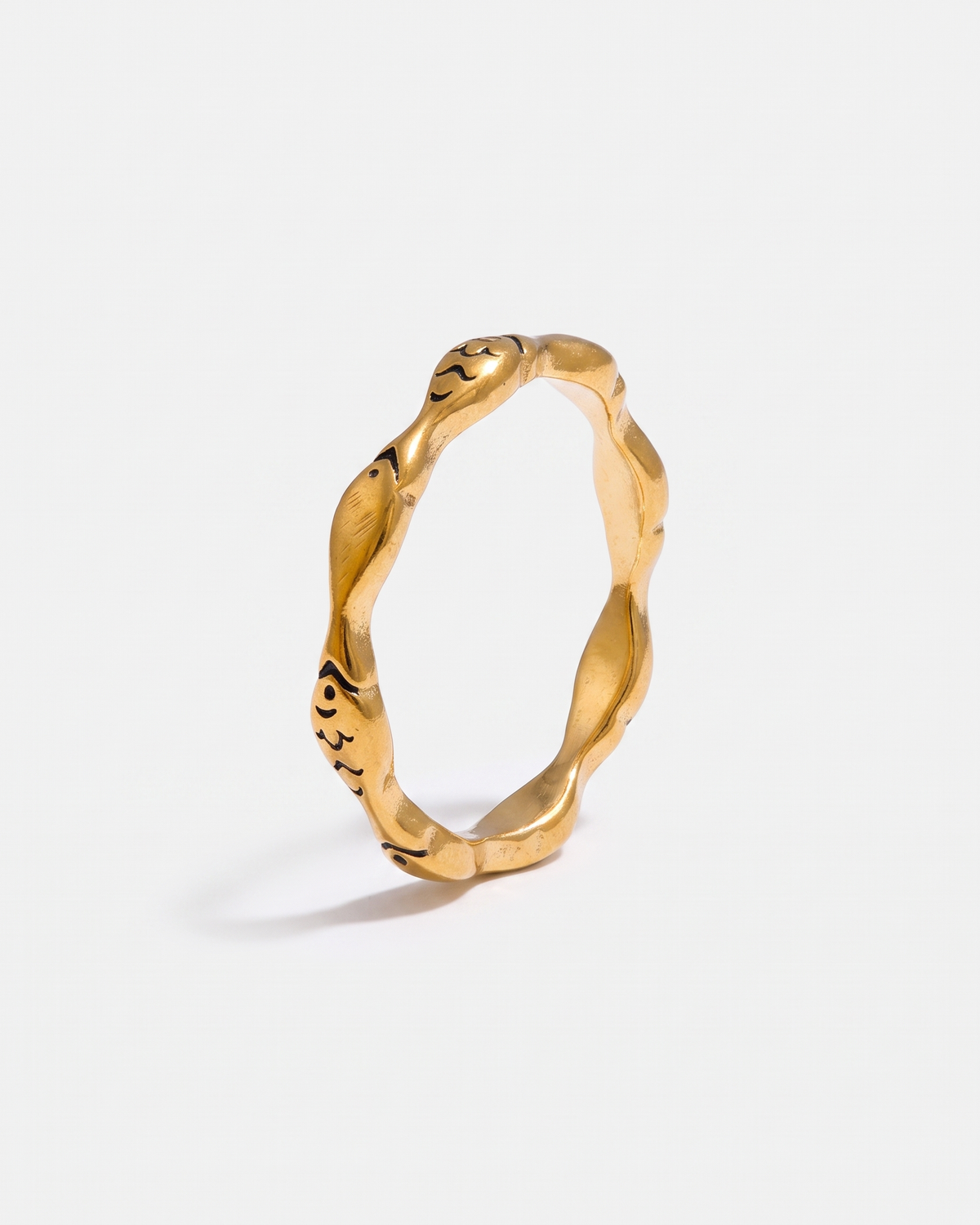 Poisson gold fish ring on off white background