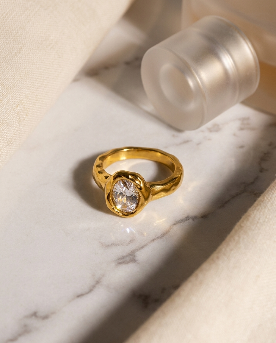 Suri Ring flatlay gold oval crystal ring on marble