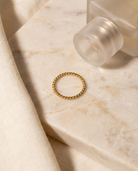 Sabine Ring flatlay on marble gold band