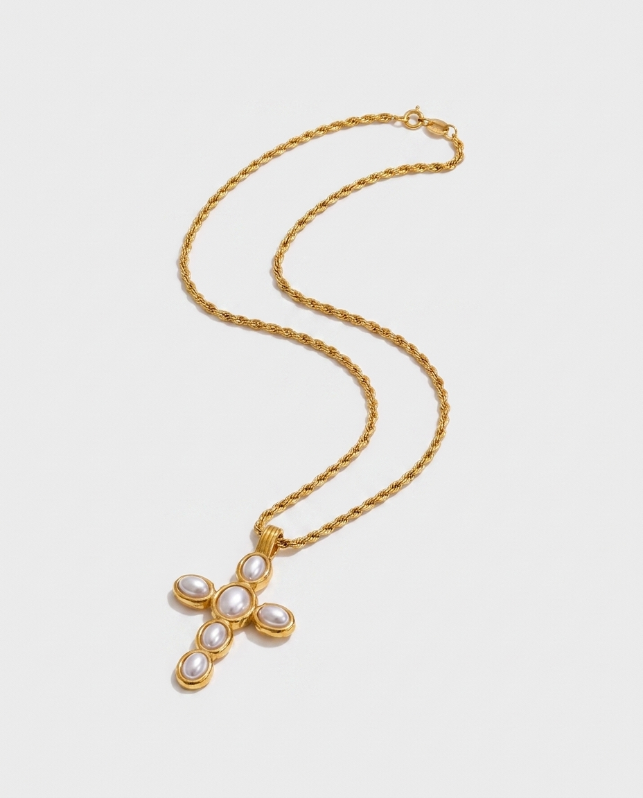 Liora Cross Necklace flatlay light grey gold cross