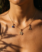 Virgo charm necklace worn, styled with birthstone and initial