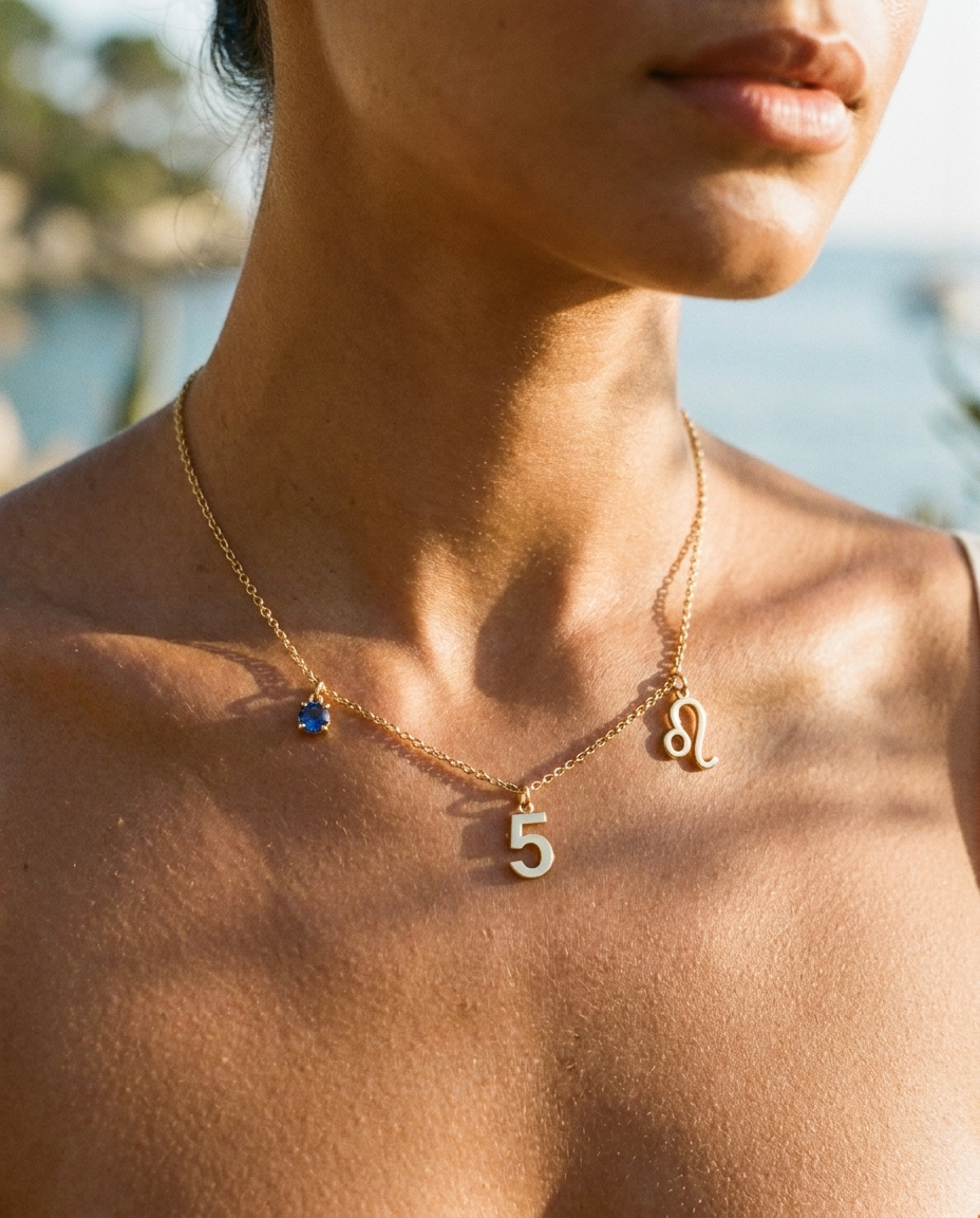 Gold number 5 charm station necklace on model with Leo zodiac and sapphire