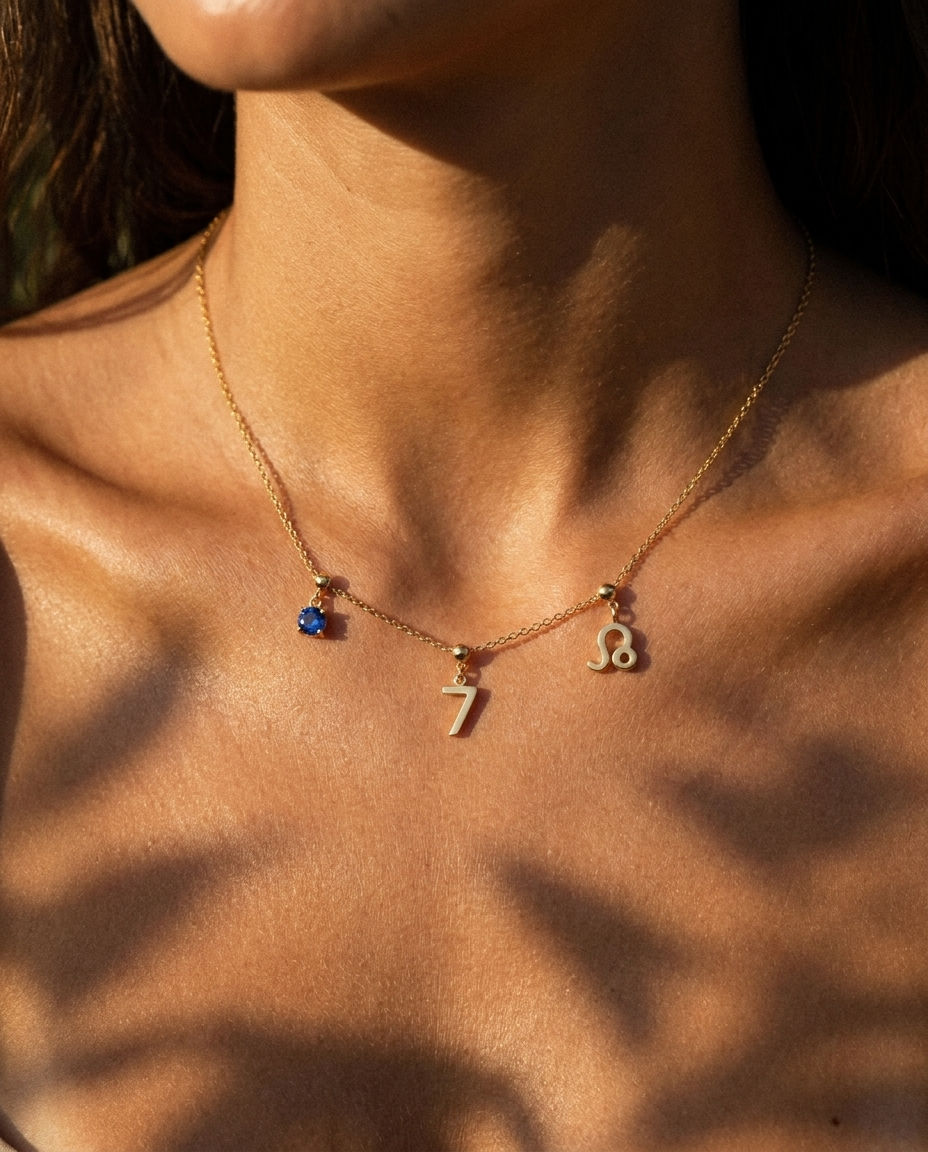 Gold number 7 charm station necklace on model with Leo zodiac and sapphire