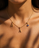 Liv Beaded Necklace styled with gold charm cluster on model
