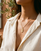 Gold zodiac Aries pendant necklace worn, warm Mediterranean crop