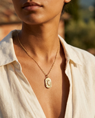 Gold zodiac Scorpio pendant necklace worn, warm Mediterranean crop