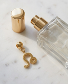 Gold zodiac Leo charm flatlay, marble