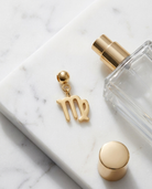 Gold zodiac Virgo charm flatlay, marble
