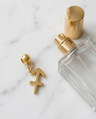 Gold zodiac Sagittarius charm flatlay, marble