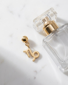 Gold zodiac Capricorn charm flatlay, marble