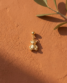 Gold bear charm flatlay, terracotta