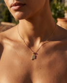 Scorpio gold zodiac charm on a fine gold chain necklace, worn