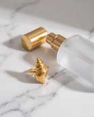 Marisol Golden Seashell Ring marble flatlay