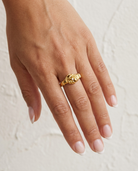 Gold Handshake Ring cream wall hand