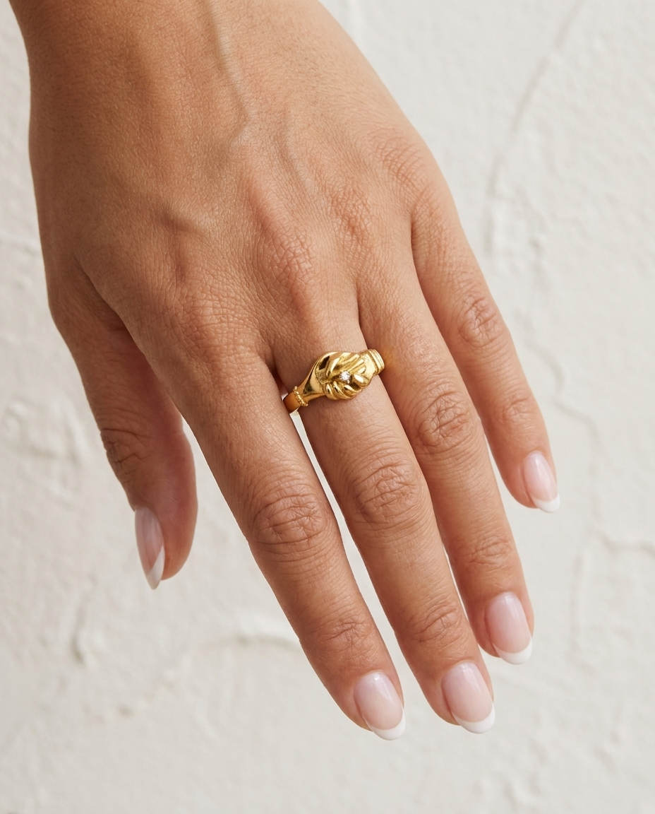 Gold Handshake Ring cream wall hand