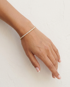 Noa Tennis Bracelet loose on wrist cream wall